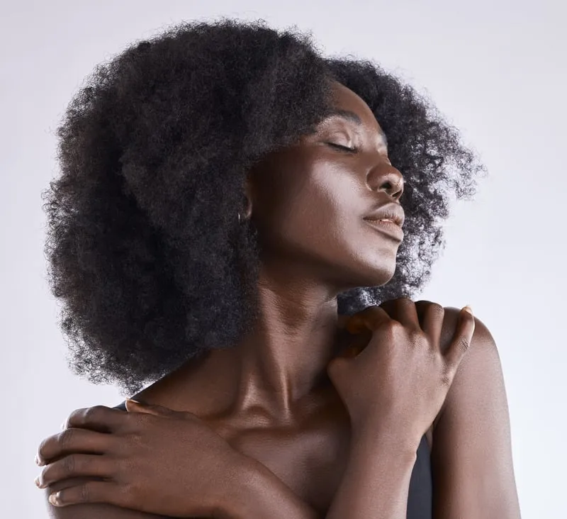 Image showing Glowing Entry: service. Lady with dark glowing skin embracing herself.